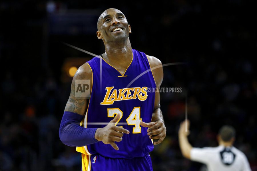 In this Dec. 1, 2015 file photo Los Angeles Lakers Kobe Bryant smiles as he jogs to the bench during the first half of an NBA basketball game against the Philadelphia 76ers in Philadelphia. The Retired NBA superstar has died in helicopter crash in Southern California, Sunday, Jan. 26, 2020. (AP Photo/Matt Slocum)