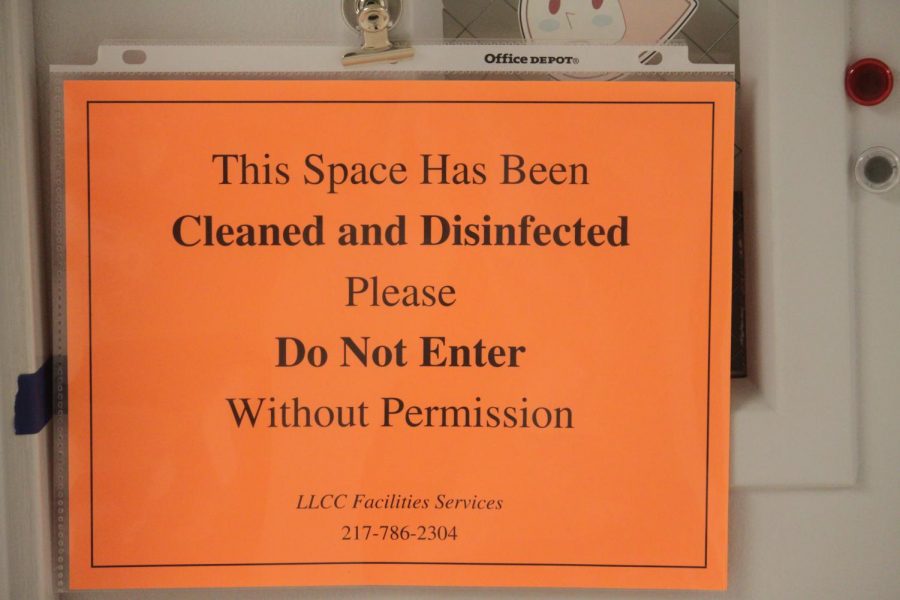 A sign informs people that an office on the second floor of Menard Hall has been cleaned and disinfected on Monday, Oct. 19, 2020. Almost every classroom and office on campus is marked with these signs as most students take their classes online.  