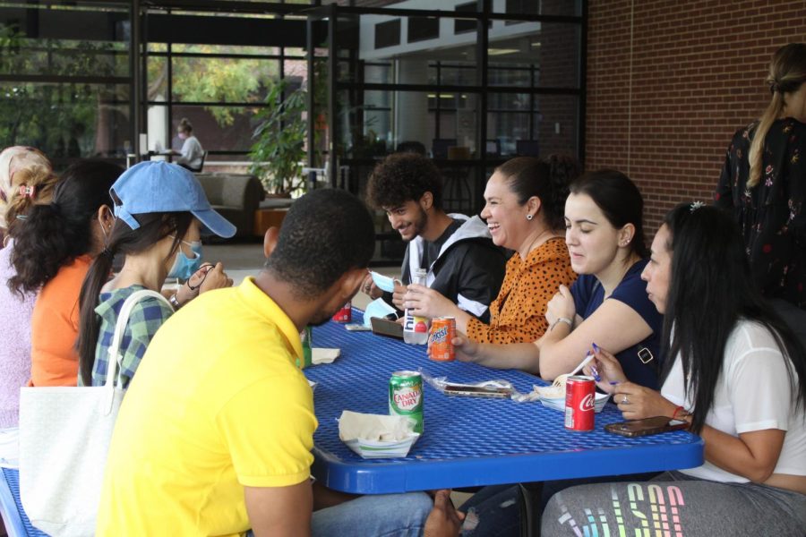 A group of student eats food from food trucks that were on campus for the popular Multicultural Festival on Wednesday, Oct. 6, 2021. 